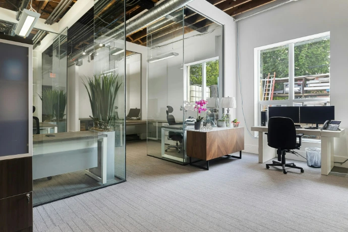 een kamer met een bureau en stoelen